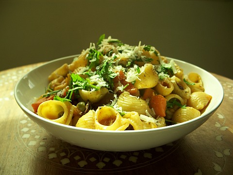Photo of a bowl of pasta with vegetables in dappled sunlight