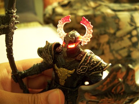 Action Figure of Dark Armoured Warrior with axe and shield, with eyes and helmet lit up