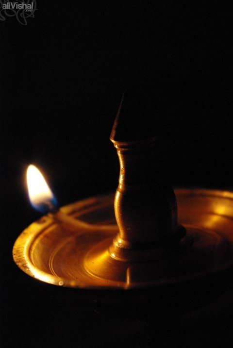 A macro shot of an oil lamp in the dark
