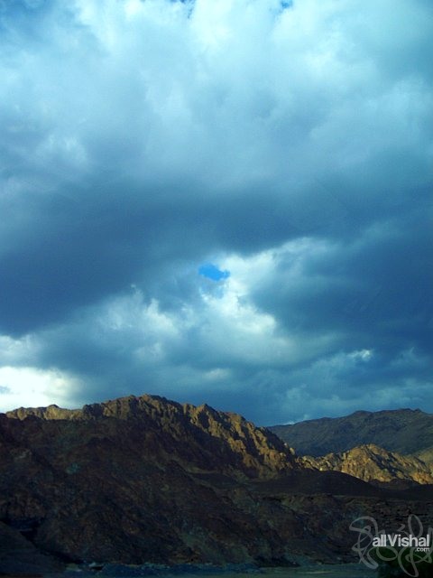 Mountains half in shadow under clouds, in Ras Al Khaimah