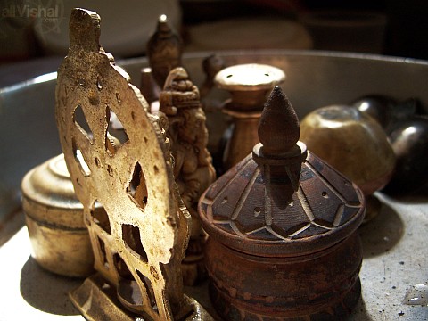 several hindu bronze and stone idols after washing