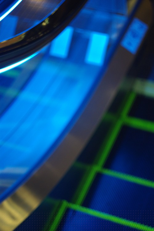 a blurry neon escalator