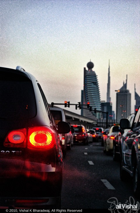 Dubai Traffic as seen from Sana fashions signal, with the Dubai Metro, Etisalat building, Trade center, Emirates Towers and Burj Khalifa in the background.