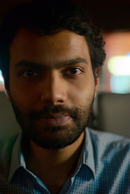 portrait of samir bharadwaj taken with a pentax k200d digital slr camera with a pentax sfx pentax-f smc 50mm F1.4 autofocus lens with cokinlight 49mm uv filter in indirect streetlight