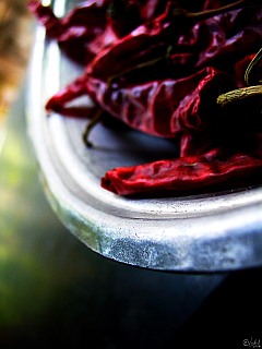 Photo of a metal bowl of dry red chillies