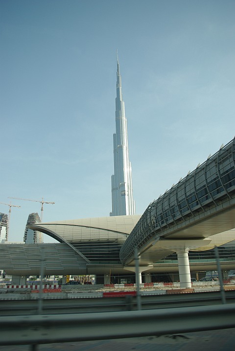 Photo of the Burj Dubai, the tallest building in the world, in the afternoon with a Dubai metro station and footbridge in the foreground